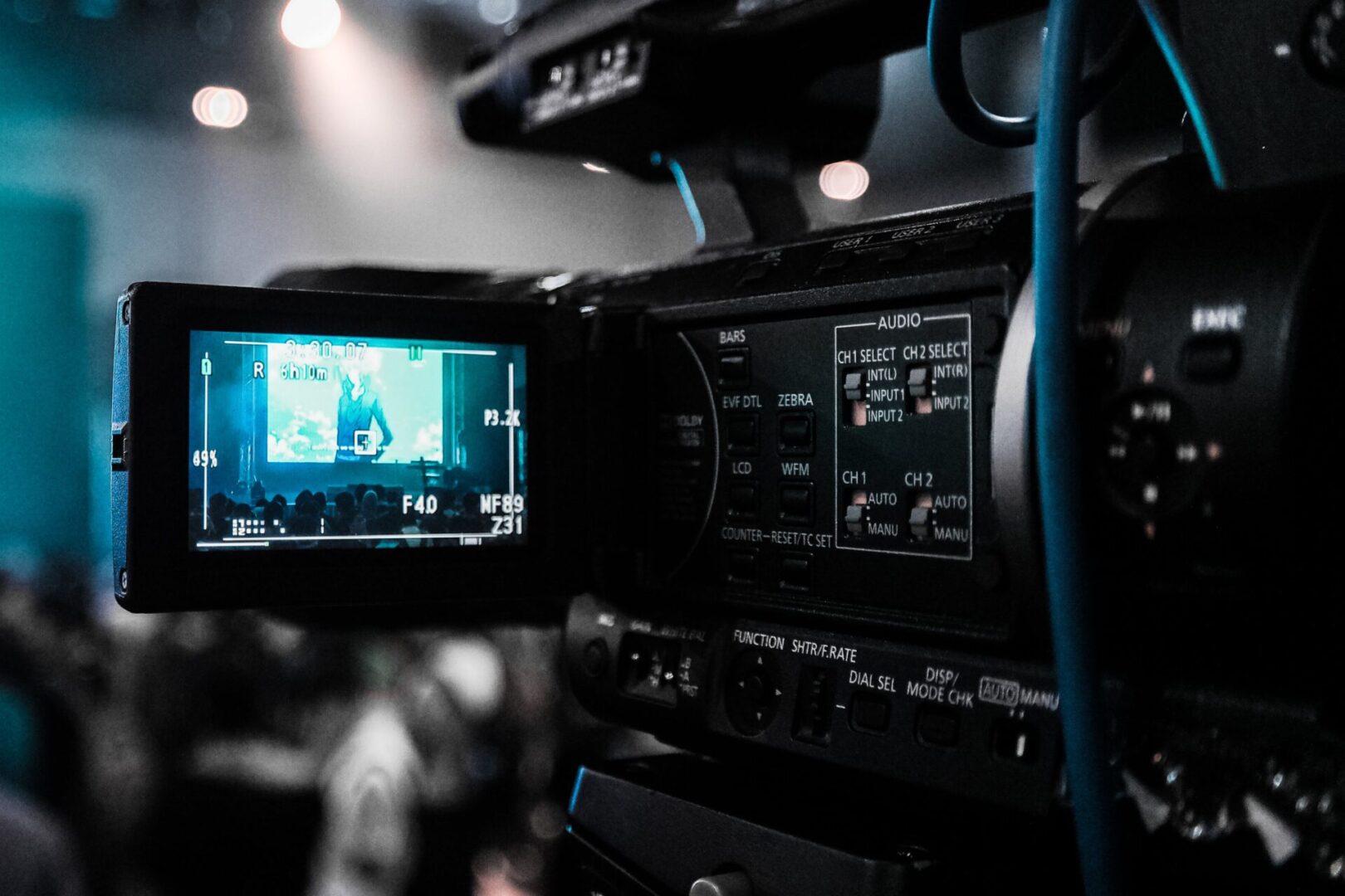 A video camera with the screen showing a man on it.